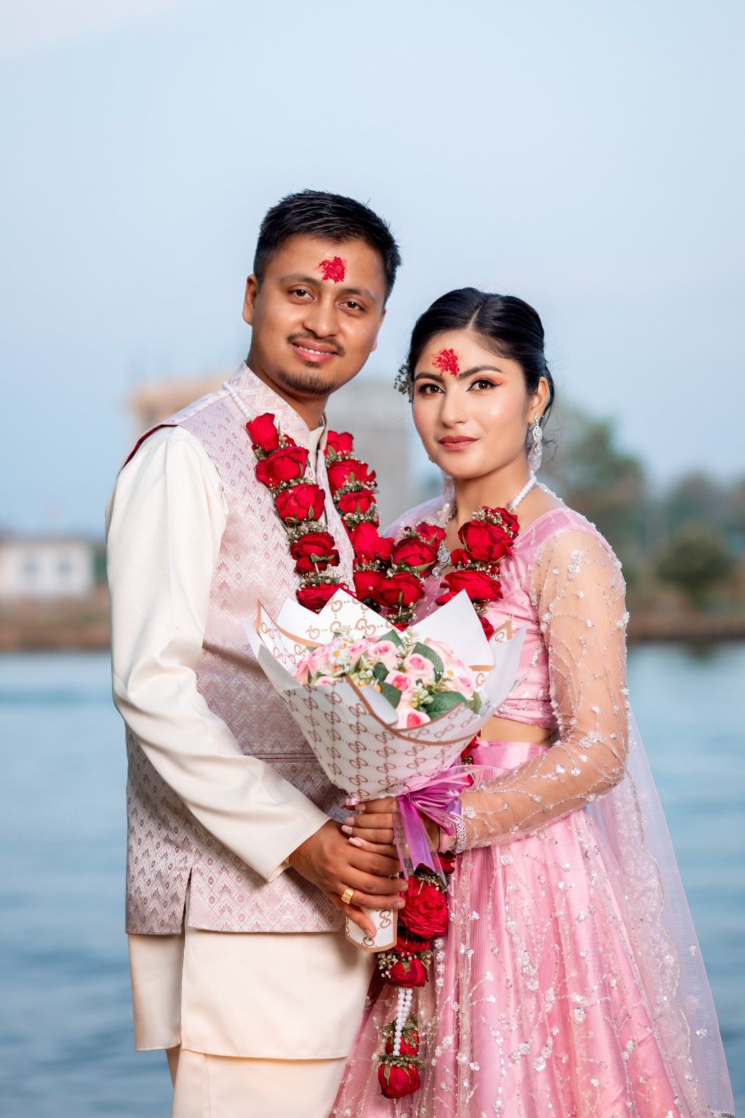 Er. Suman Khadka and Mrs. Baneeka Thapa Khadka in traditional attire by the water